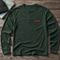 Alaska State Upside Down embroidery design stitched on a forest green long-sleeve henley