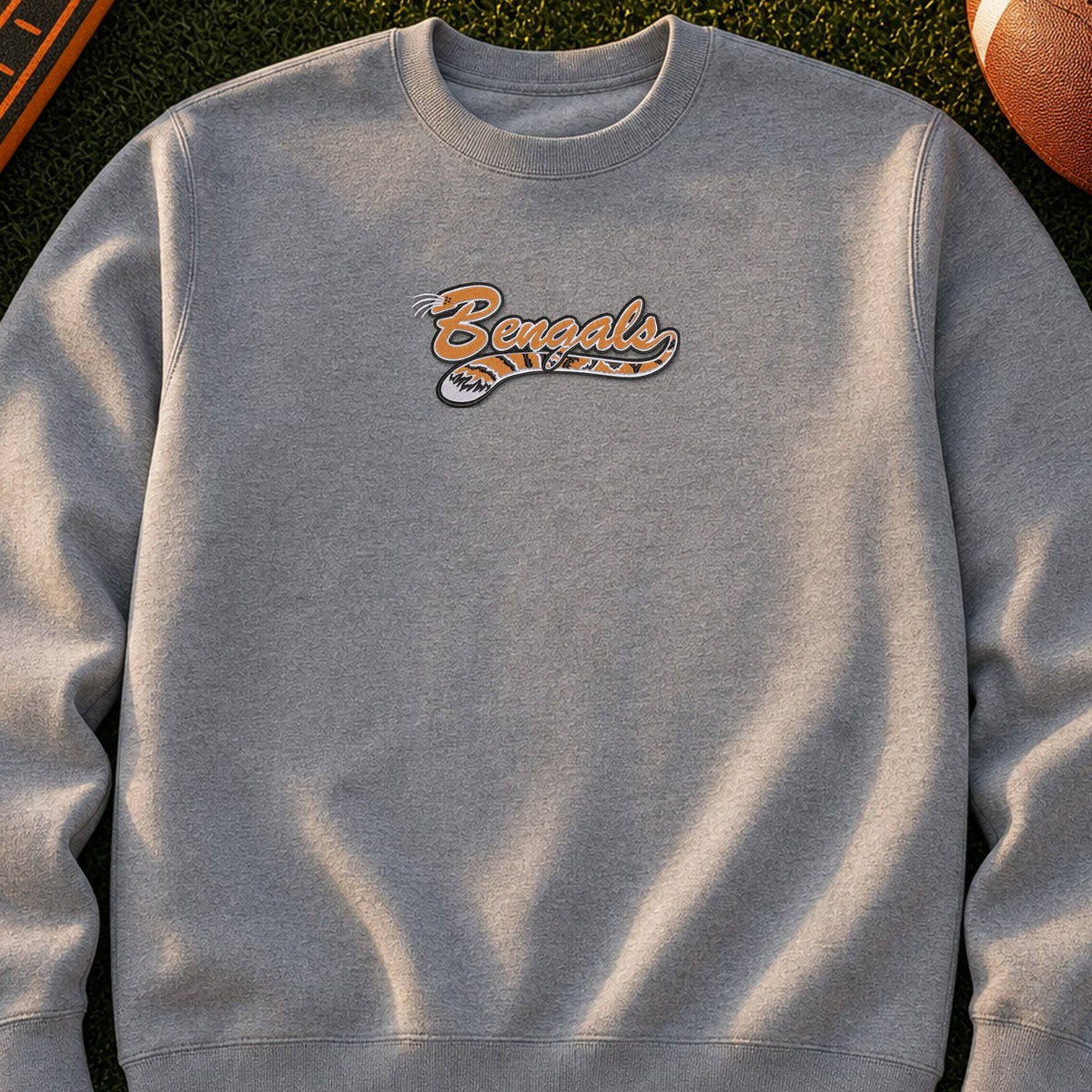 Bengals Mascot Tail embroidery design stitched on a heather grey unisex midweight crewneck sweatshirt
