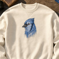 BlueJay Bird Head Threads embroidery design stitched on a natural cream heavyweight fleece crewneck sweatshirt