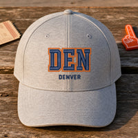 DEN Puff Cap embroidery design stitched on a dove grey heather structured six-panel baseball cap