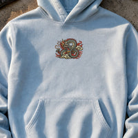 Dragon Tattoo embroidery design stitched on a light sky-blue heavyweight pullover hoodie