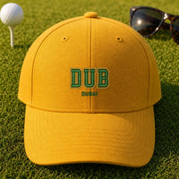 DUB Puff Cap embroidery design stitched on a mustard yellow structured six-panel baseball cap