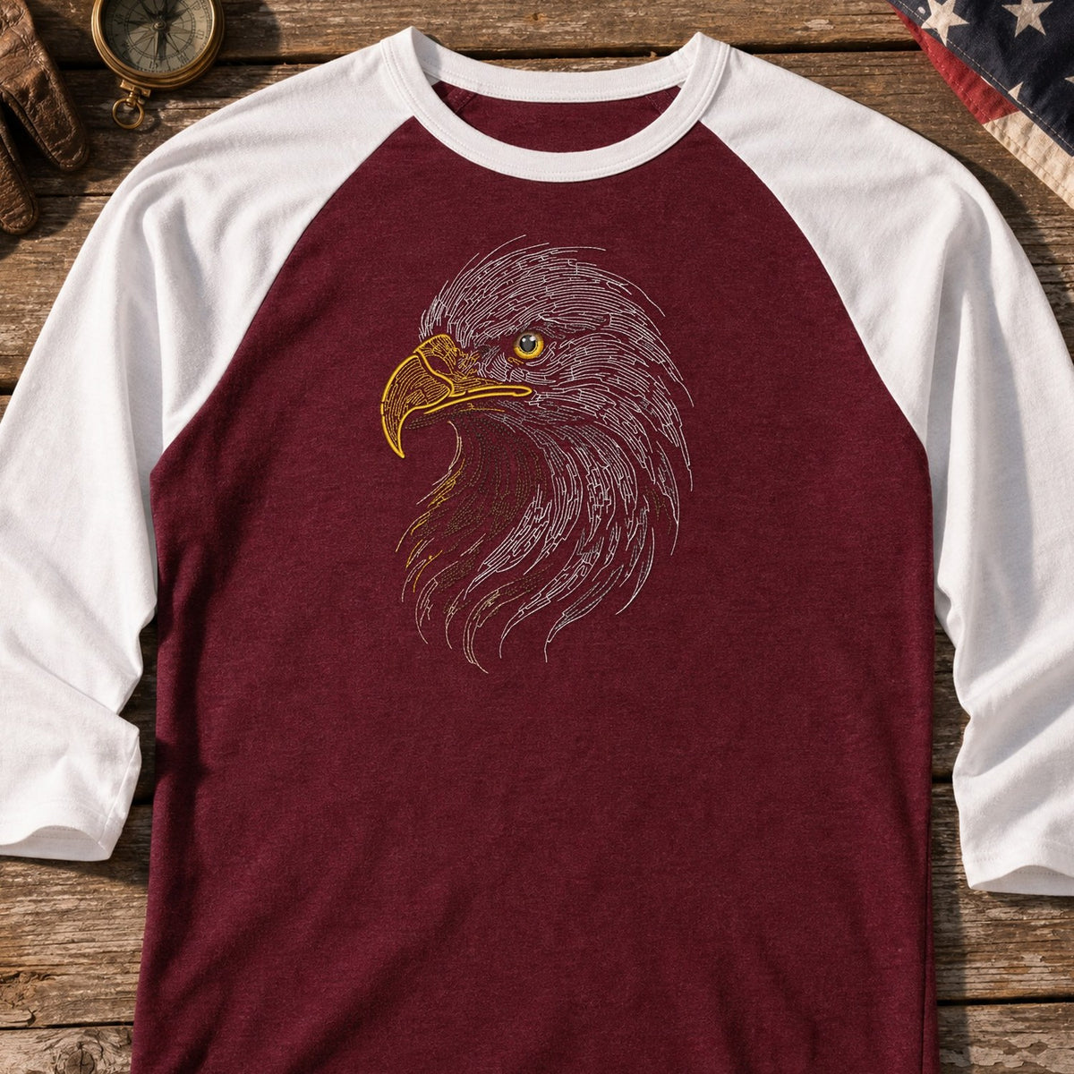 Eagle Head Run embroidery design stitched on a maroon baseball raglan shirt