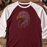 Eagle Head Run embroidery design stitched on a maroon baseball raglan shirt