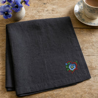 Flower Heart Blue Pansy embroidery design stitched on a charcoal linen tea towel