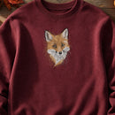 Fox Head Threads embroidery design stitched on a maroon heavy-weight fleece crewneck sweatshirt