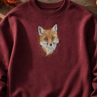 Fox Head Threads embroidery design stitched on a maroon heavy-weight fleece crewneck sweatshirt