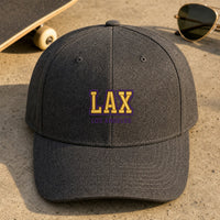 LAX Puff Cap embroidery design stitched on a charcoal heather structured six-panel baseball cap