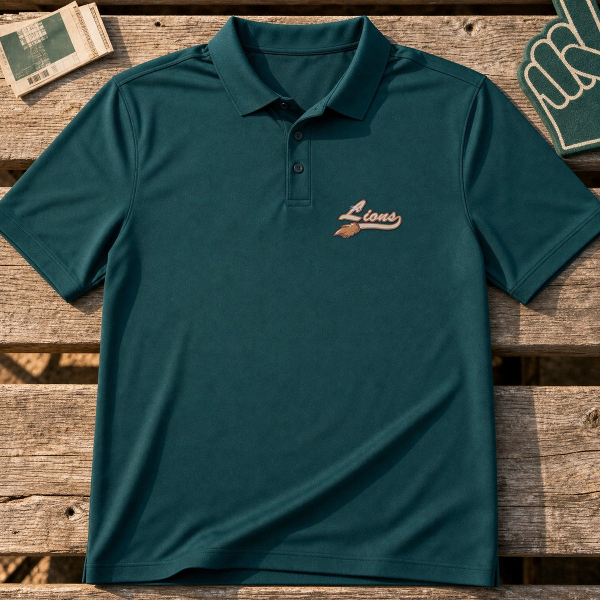 Lions Mascot Tail embroidery design stitched on a deep teal performance polo