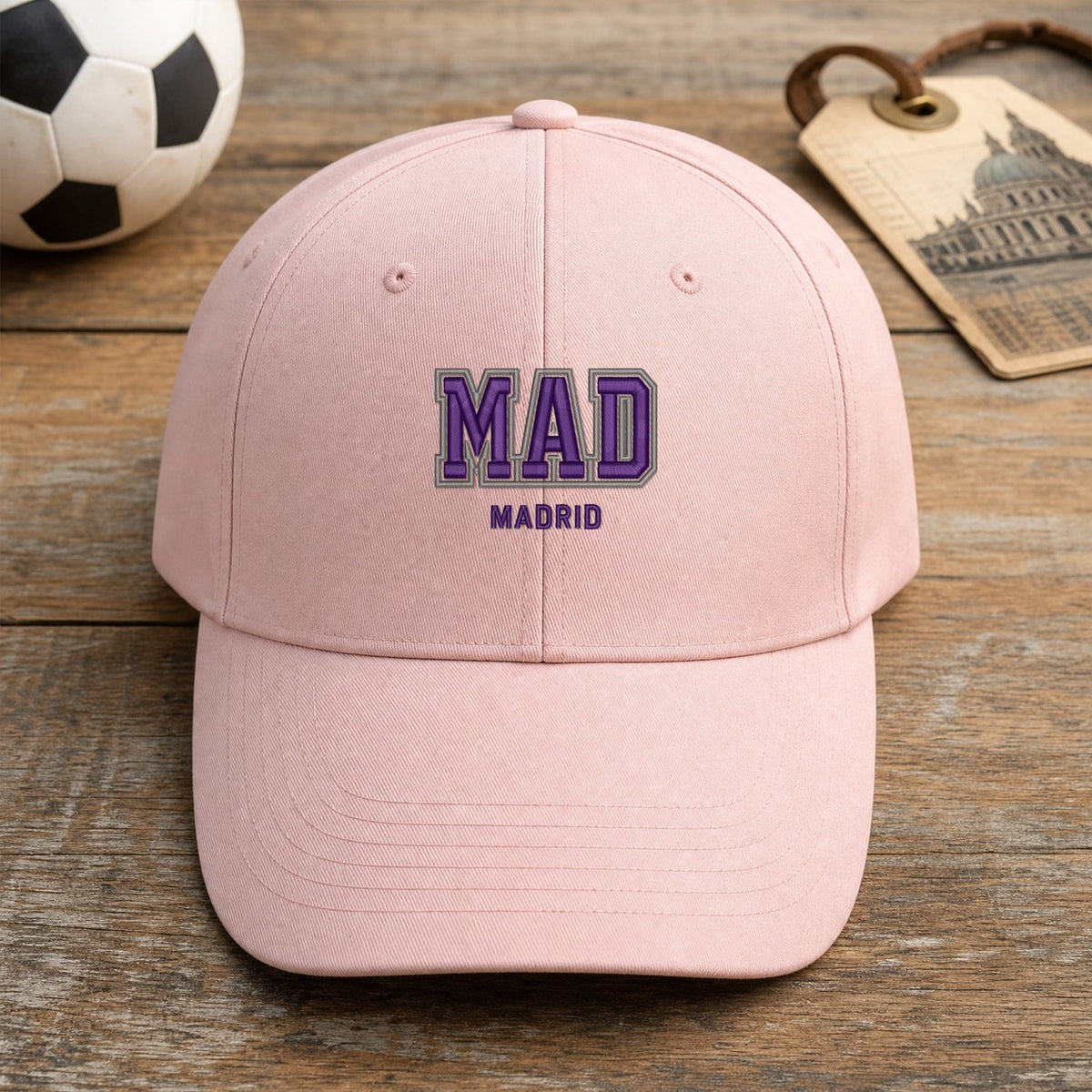 MAD Puff Cap embroidery design stitched on a soft blush pink structured six-panel baseball cap