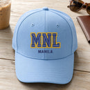 MNL Puff Cap embroidery design stitched on a light sky blue structured six-panel baseball cap