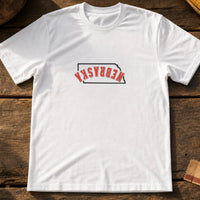 Nebraska State Upside Down embroidery design stitched on a crisp white unisex short-sleeve tee