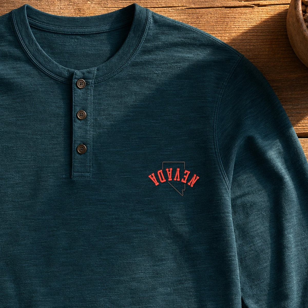 Nevada State Upside Down embroidery design stitched on a deep teal long-sleeve slub henley