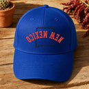 New Mexico State Upside Down embroidery design stitched on a royal blue structured six-panel baseball cap