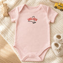 New York State Upside Down embroidery design stitched on a soft blush pink organic cotton baby onesie