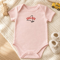 New York State Upside Down embroidery design stitched on a soft blush pink organic cotton baby onesie