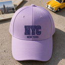 NYC Puff Cap embroidery design stitched on a light lavender structured six-panel baseball cap