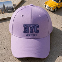 NYC Puff Cap embroidery design stitched on a light lavender structured six-panel baseball cap