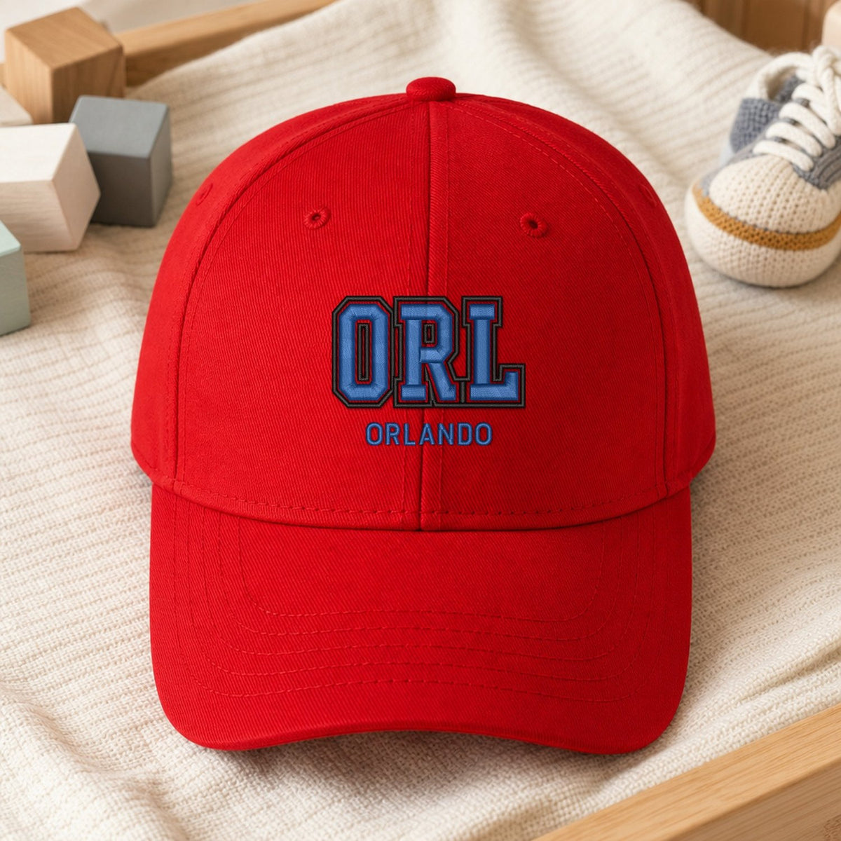 ORL Puff Cap embroidery design stitched on a vibrant red structured six-panel baseball cap