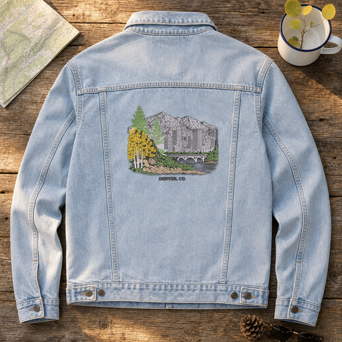 Peek at Denver embroidery design stitched on the back of a light stonewash denim trucker jacket