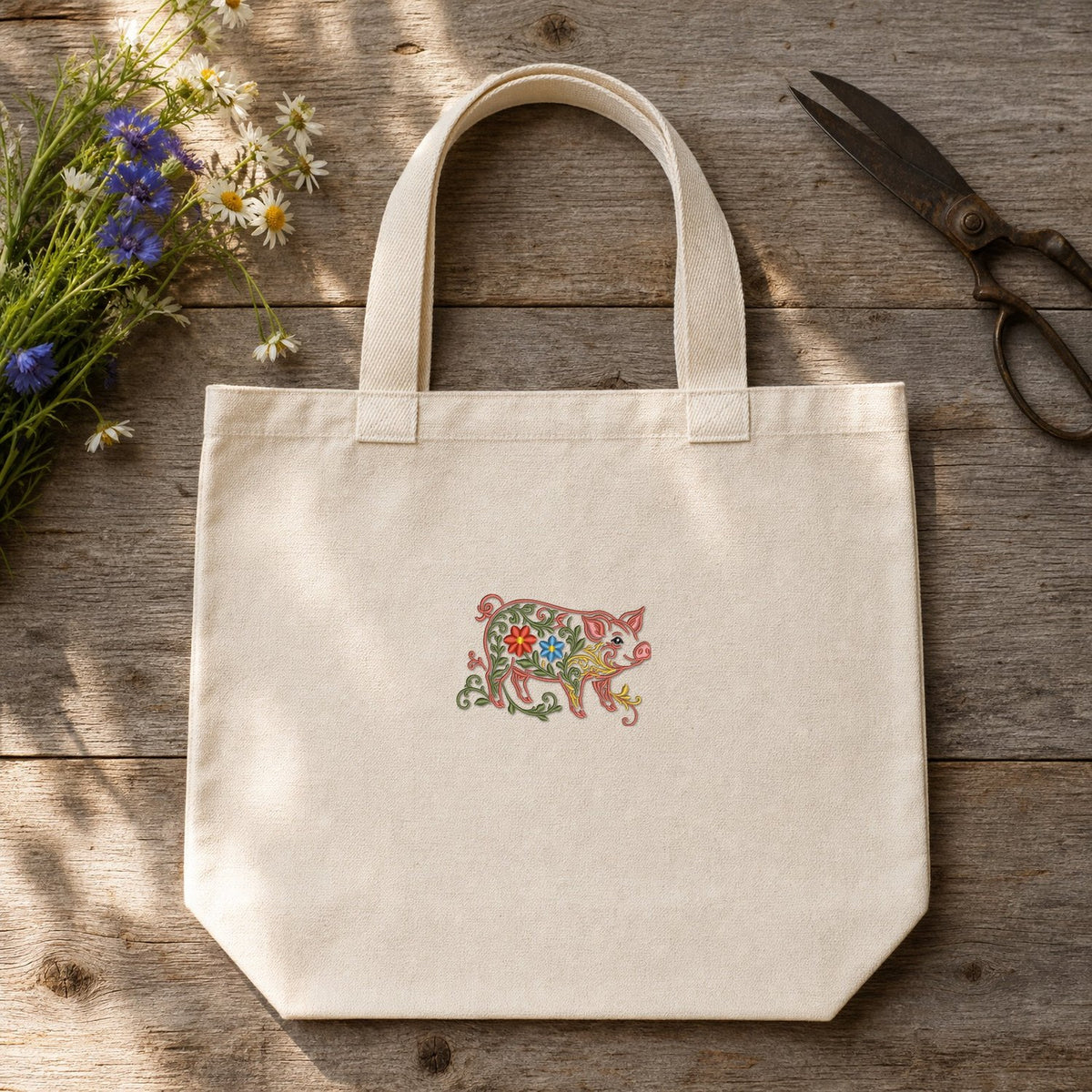 Pig Filled Flowers embroidery design stitched on a 15-inch natural unbleached canvas market tote bag