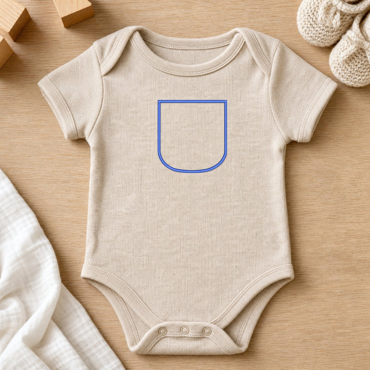 Pocket Applique Patch 2 embroidery design stitched on a sand heather short-sleeve baby onesie