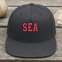 SEA Puff Cap embroidery design stitched on a charcoal structured mid-profile snapback cap