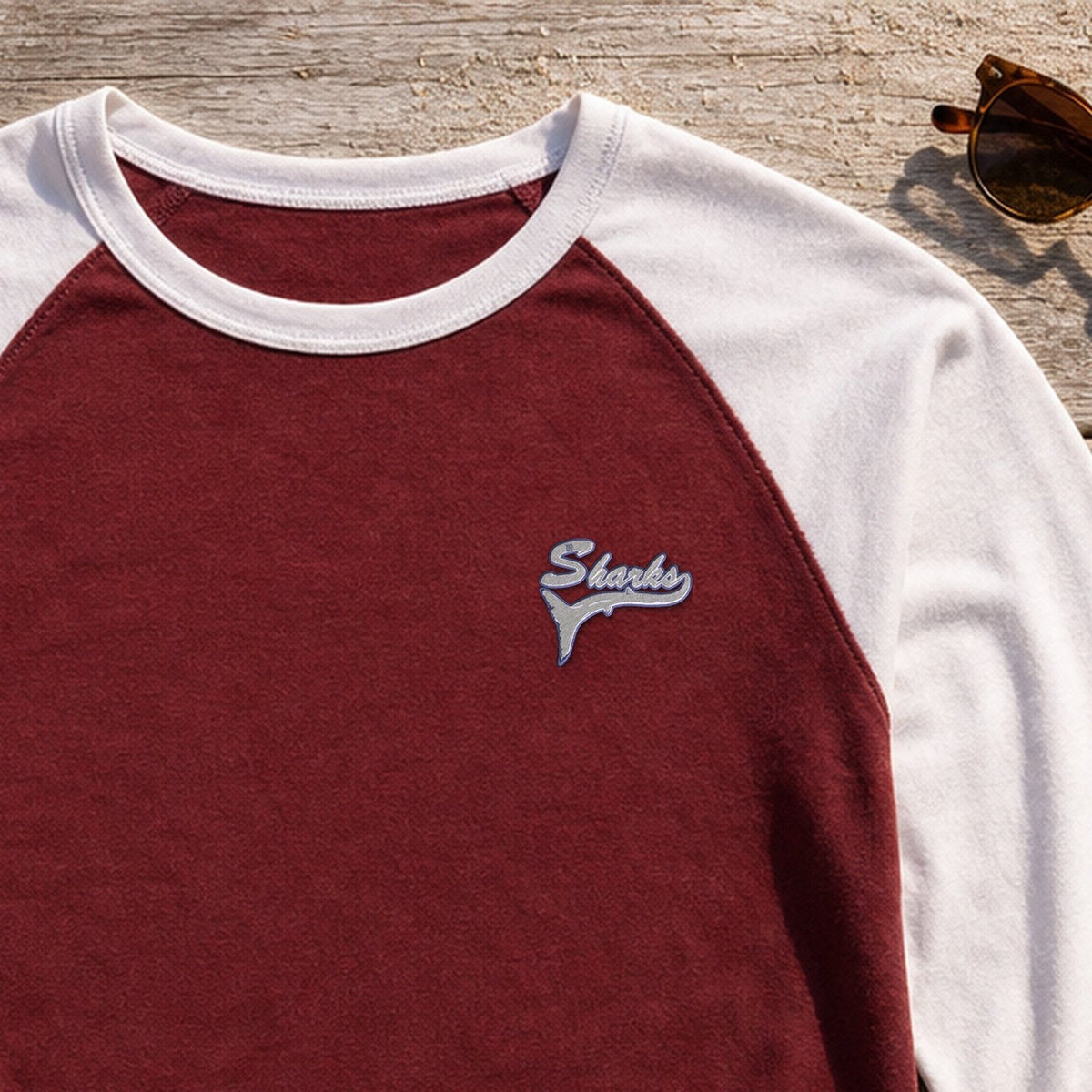 Sharks Mascot Tail embroidery design stitched on a maroon baseball raglan tee