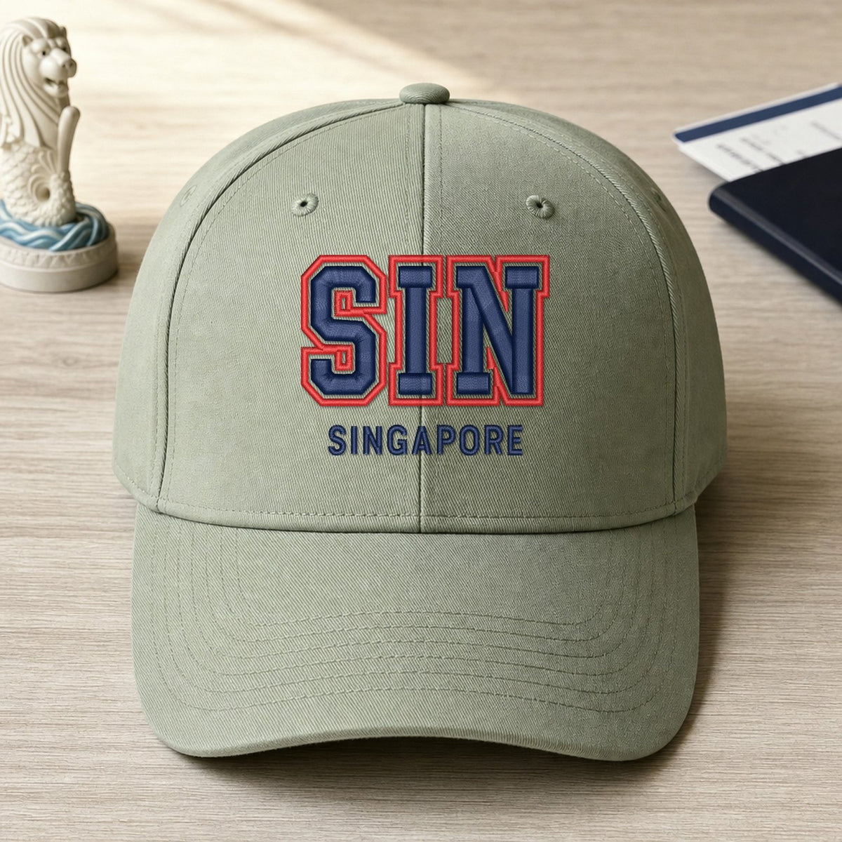 SIN Puff Cap embroidery design stitched on a sage structured six-panel baseball cap