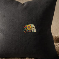 Skull Sunflowers embroidery design stitched on a charcoal linen throw pillow