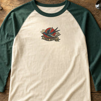 Swallow Free Spirit Tattoo embroidery design stitched on a vintage cream baseball raglan tee