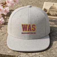 WAS Puff Cap embroidery design stitched on a light heather grey structured 6-panel snapback cap