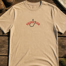 West Virginia State Upside Down embroidery design stitched on a sand unisex short-sleeve cotton tee